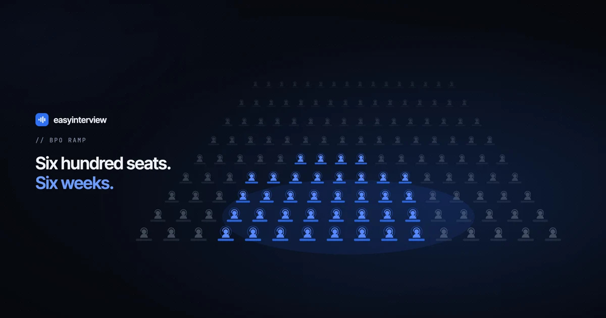 A call-centre floor in perspective; a block of headset seats is lit blue against a much larger empty floor